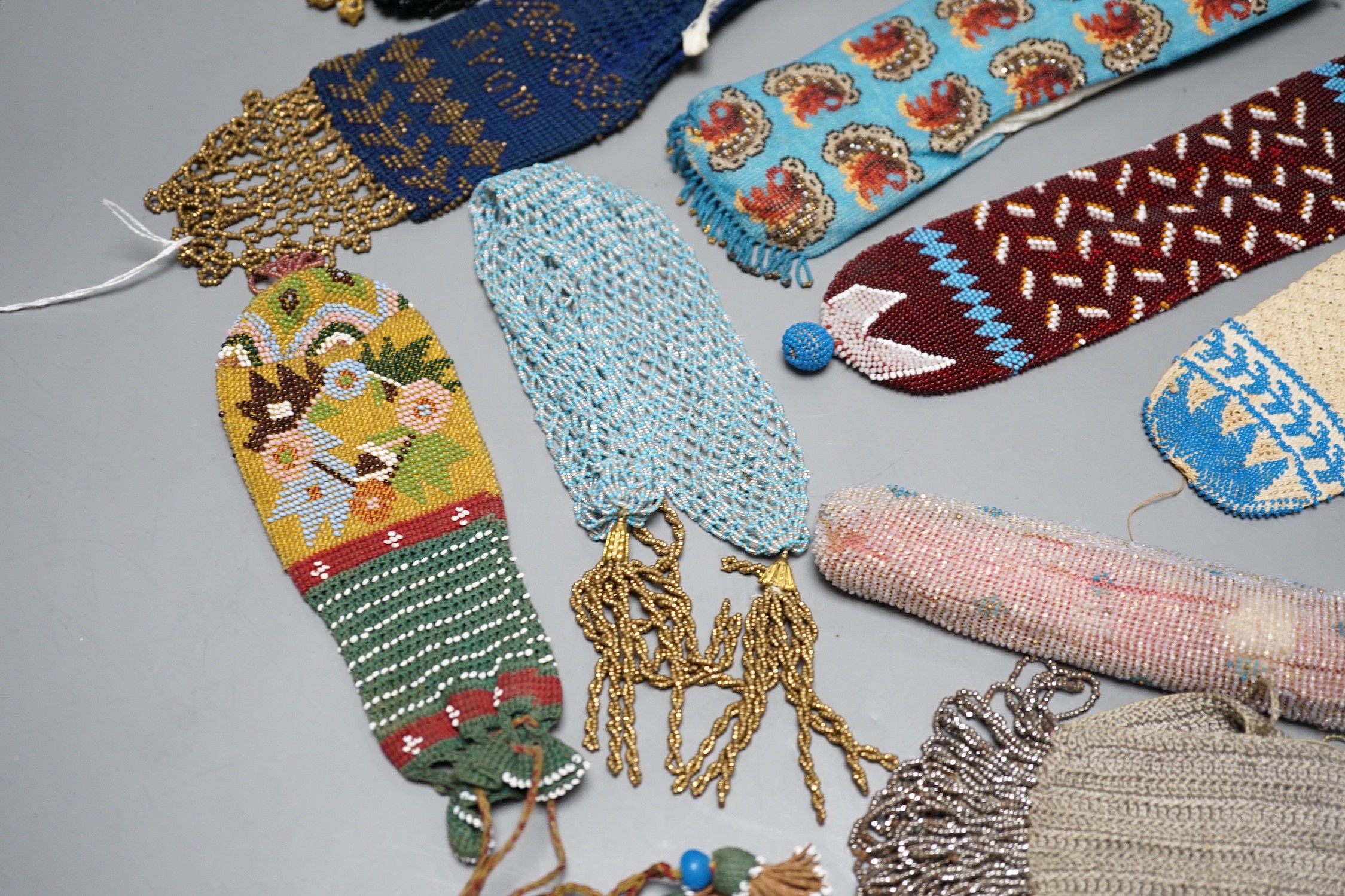 A collection of nine Berlin beadwork miser's purses and three panels, longest 26cm